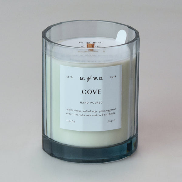 Candle with a label on a light blue background
