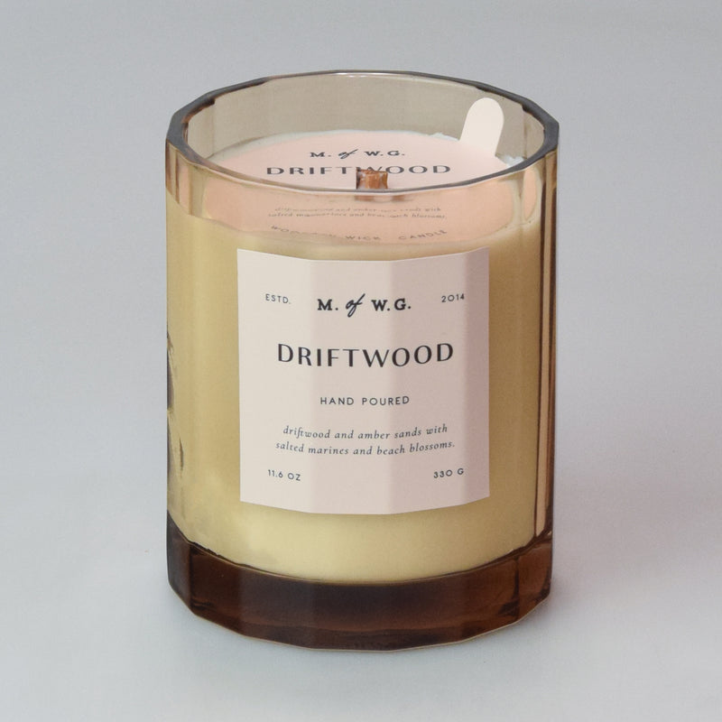 Candle with a label on a tan background