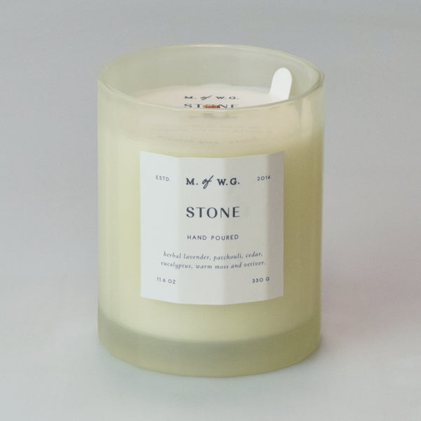 Candle with a label on a cream background